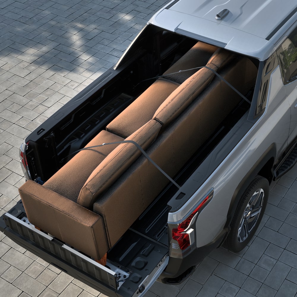 A couch stowed on the cargo bed of the 2026 Chevrolet Silverado EV.