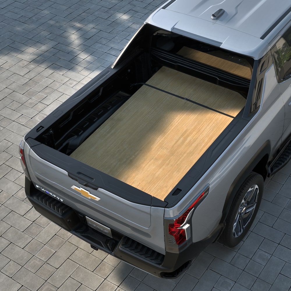 A wooden board stowed on the cargo bed of the 2026 Chevrolet Silverado EV.