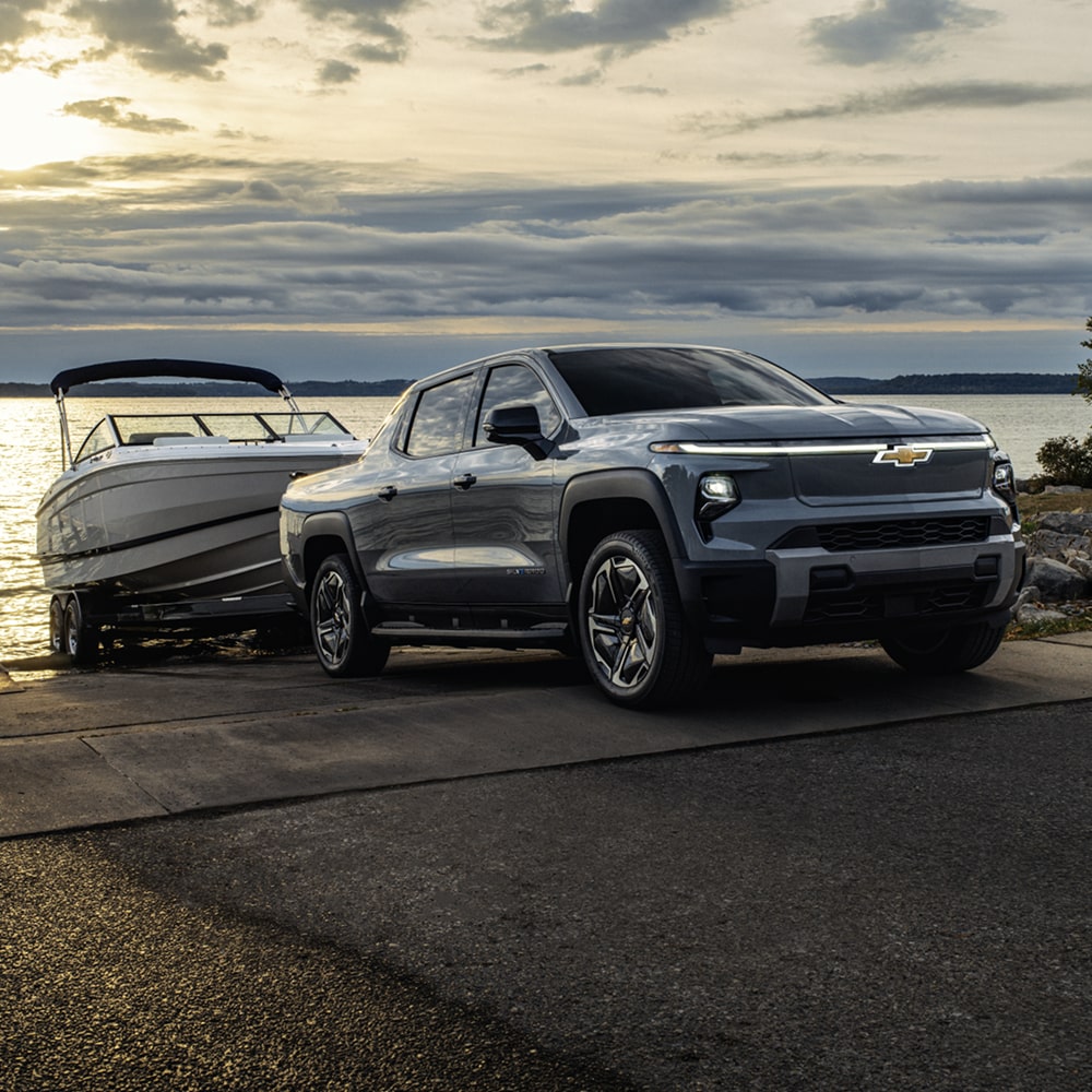 2026 Chevrolet Silverado EV towing a Boat from the Lake.