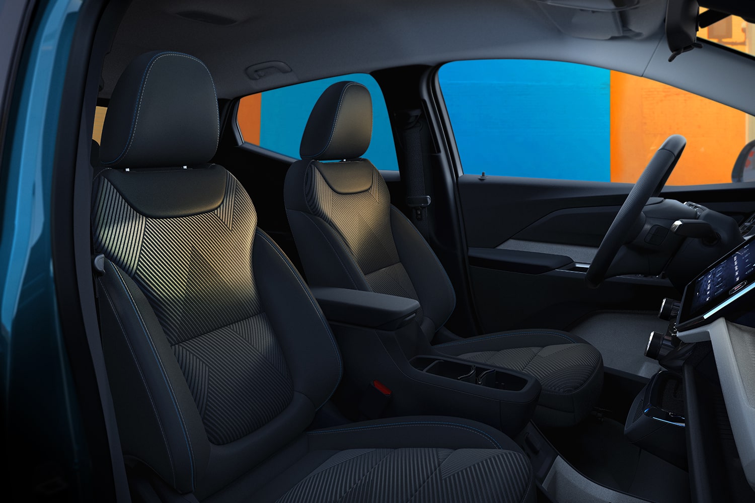 The Front Interior of a 2027 Chevrolet Bolt Shows the Black and Gray Textured Fabric Front Seats and the Center Armrest with a Storage Compartment.