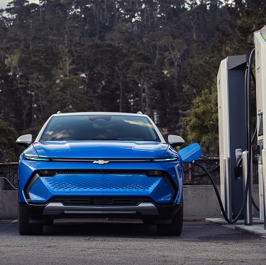 Front View of a Blue Equinox Parked and Charging at a Public Charging Station