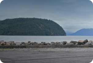 A Road by the Ocean Bordered by Rocks Surrounded by Islands