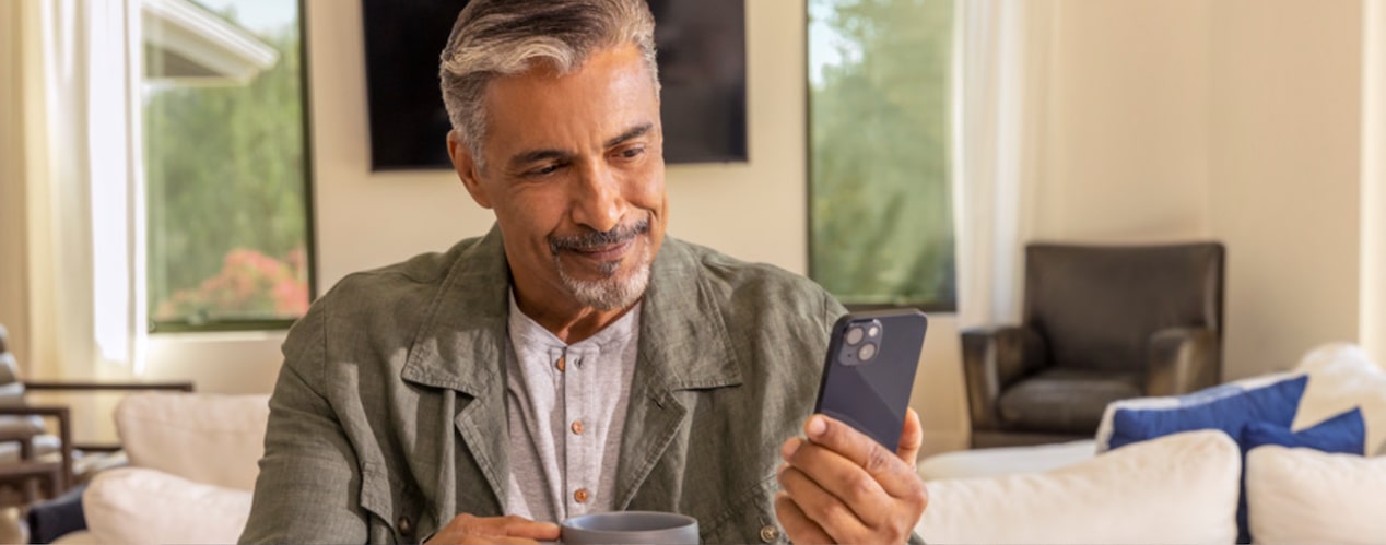 A person using his MyChevrolet app through his smartphone at home.
