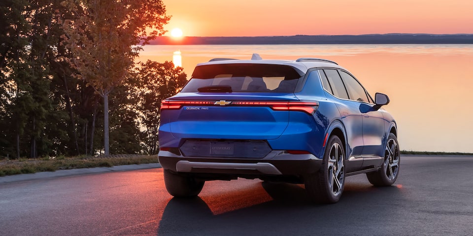 2024 Equinox EV Rear Shot of Vehicle Parked at Sunset