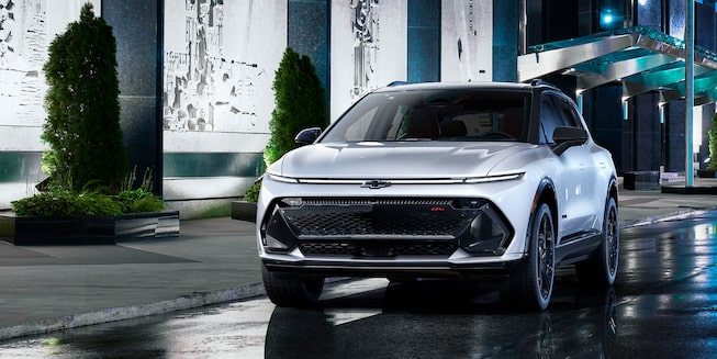 2024 Equinox EV Front 3/4 of Drivers Side on City Street at Night