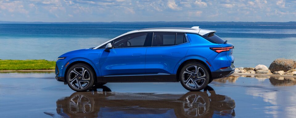 2024 Equinox EV Driver's Side Profile Shot on Reflective Surface