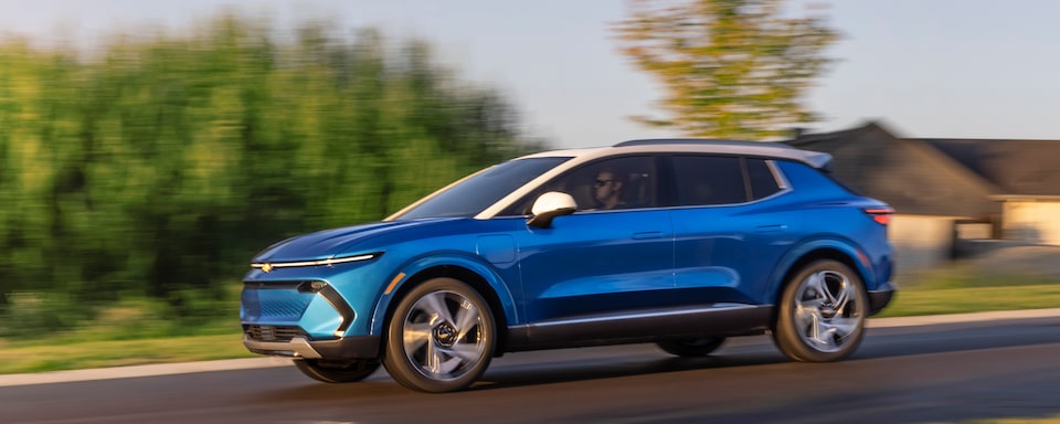2024 Equinox EV Drivers Side Shot of Vehicle in Motion on Road