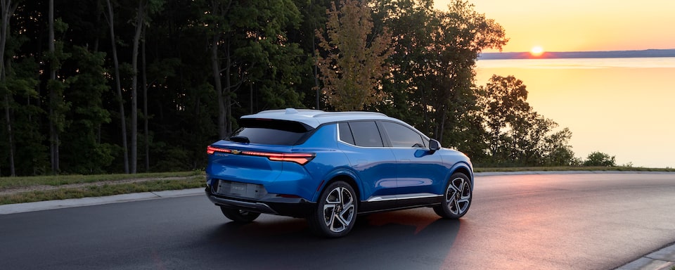2024 Equinox EV Rear 3.4 Shot of Vehicle at Sunset