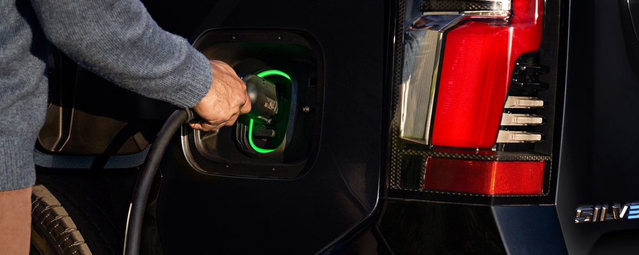 Person Plugging in their Chevrolet Silverado EV