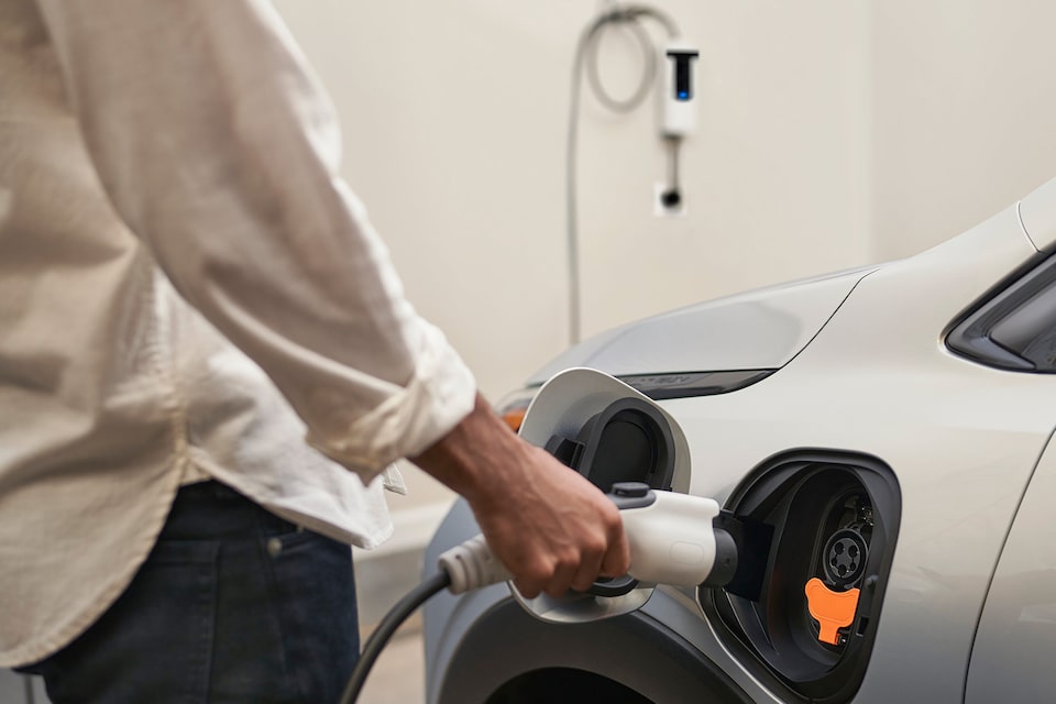 A person charging his Chevrolet EV at home in his garage.