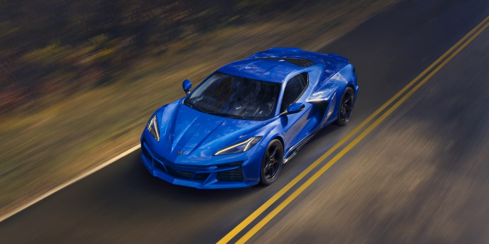 Overhead View of a Blue Chevrolet Corvette E-Ray Driving Down the Road.