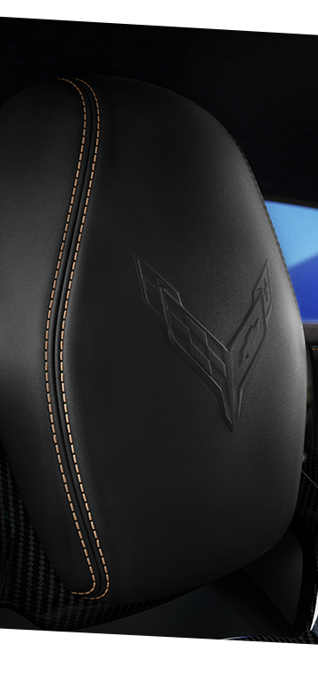 Close-up view of the Corvette logo etched on the seat headrest of the 2026 Chevrolet Corvette E-Ray.