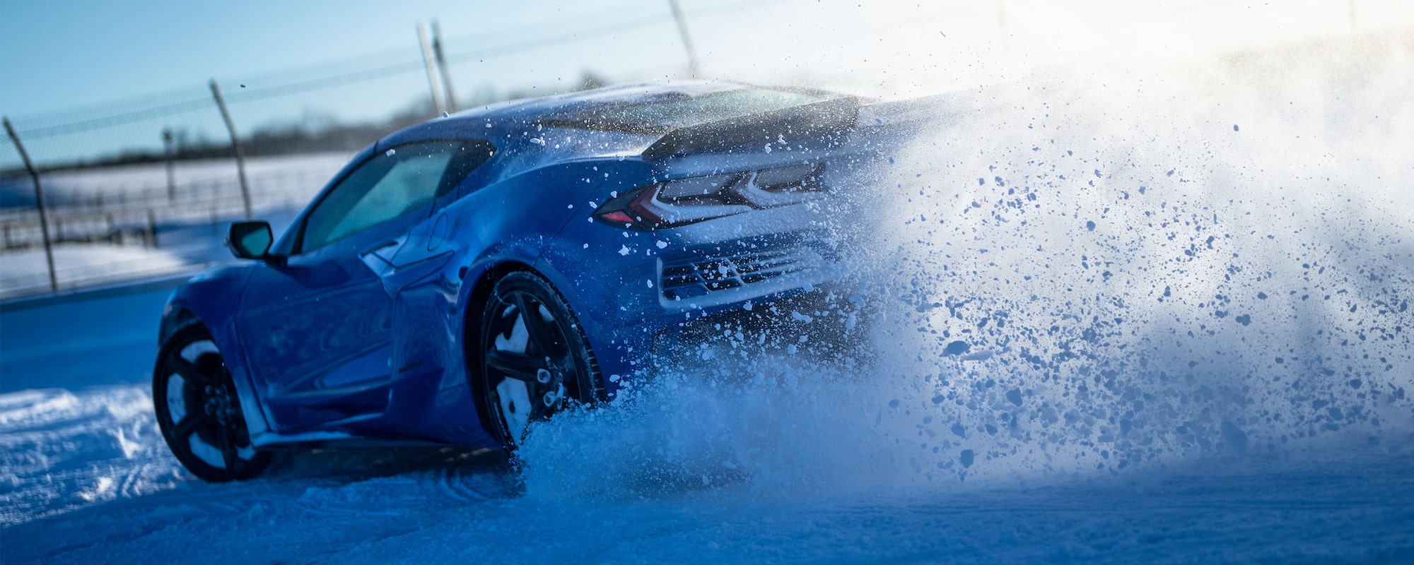 2026 Chevrolet Corvette E-Ray drifting on a snowy surface.