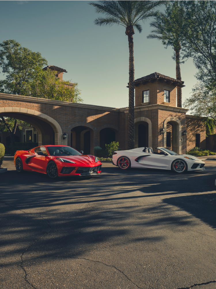 Two 2026 Chevrolet Corvette Stingray Sports Cars Parked in Front of a House.