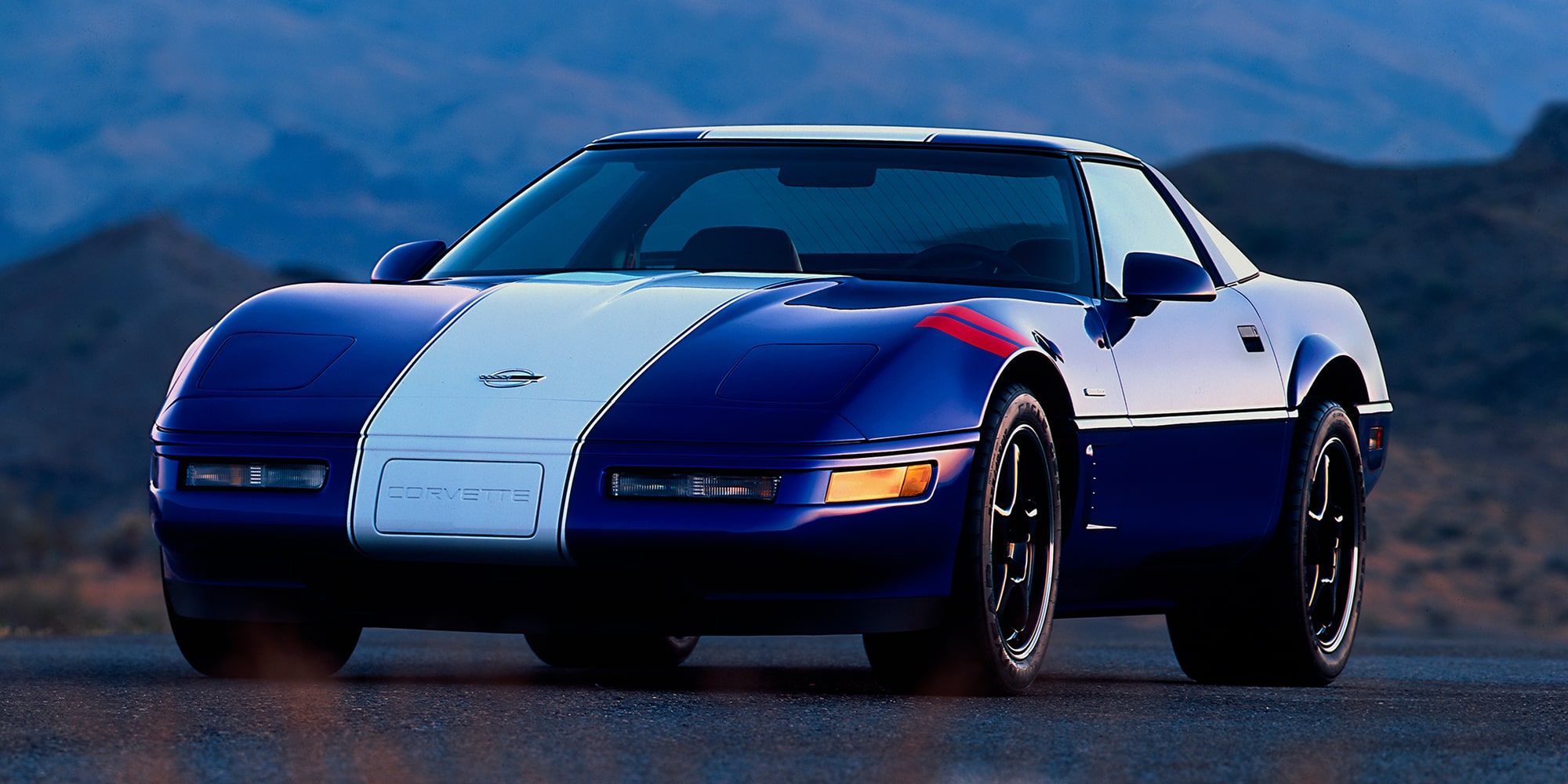 A Classic 1996 Chevrolet Corvette Grand Sport in Blue with a White Center Stripe.