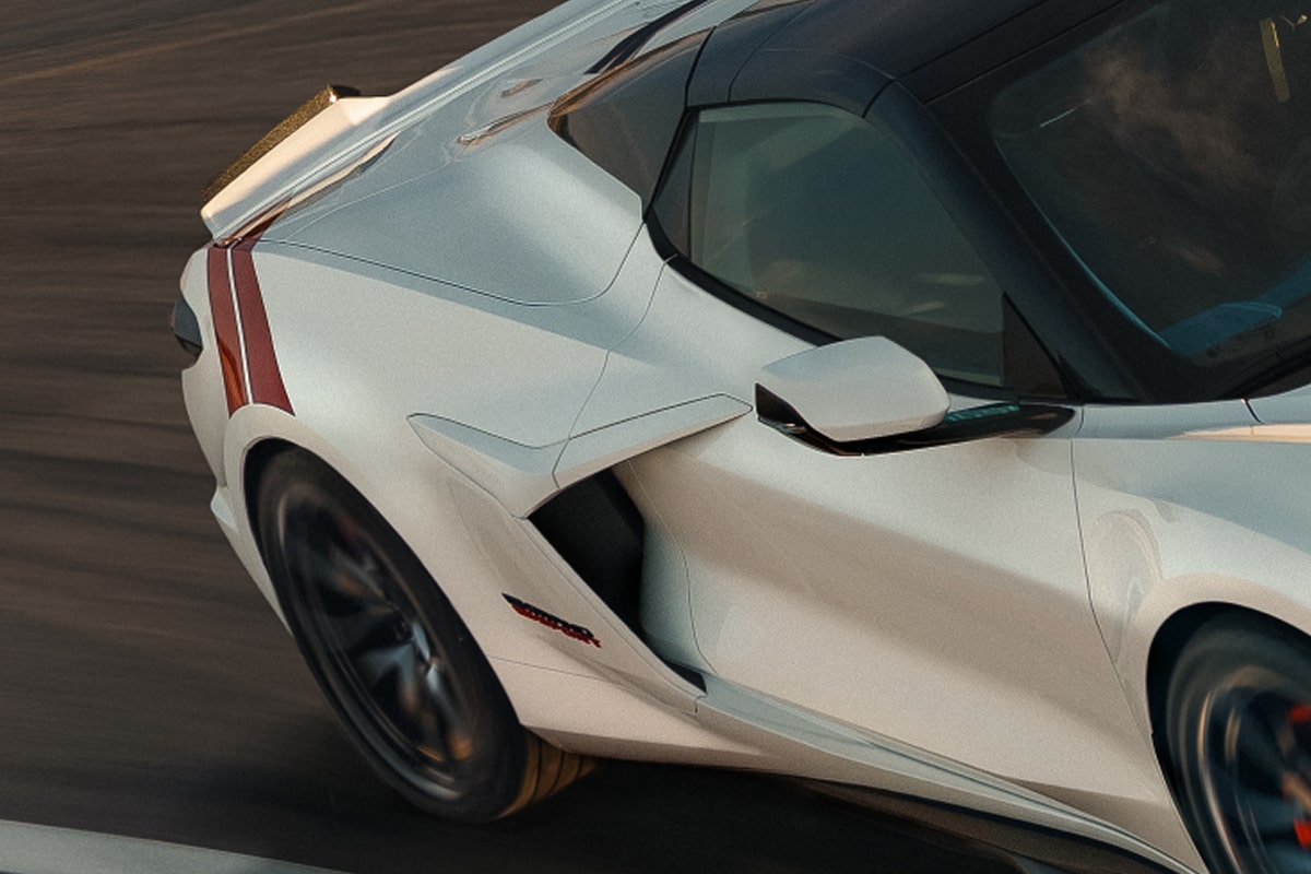 A White 2027 Chevrolet Corvette Grand Sport Speeds Through a Sunlit Corner.