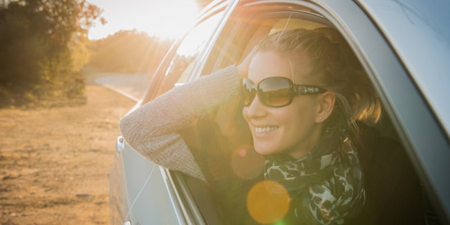 A woman in a car that works for a company eligible for GM's Preferred Pricing Program.