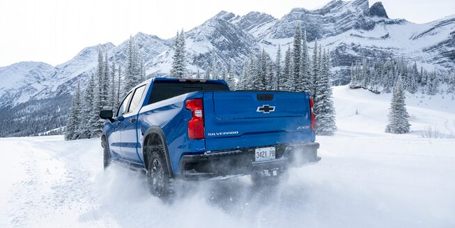 Rear view of the 2023 Silverado ZR2 on snowy terrain.