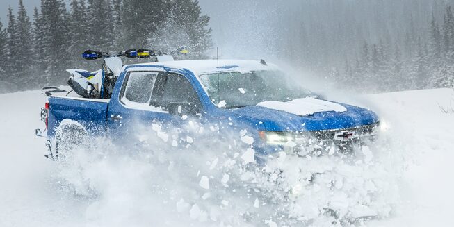 Right side view of the 2023 Silverado ZR2 on snowy terrain.
