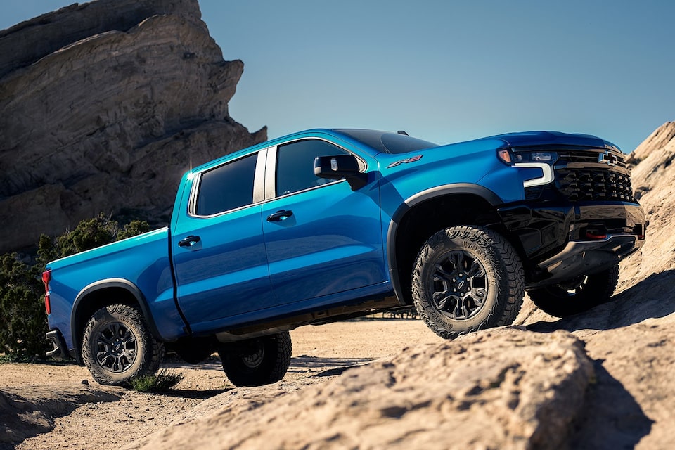 A 2024 Chevrolet Silverado 1500 driving on a rocky cliff.