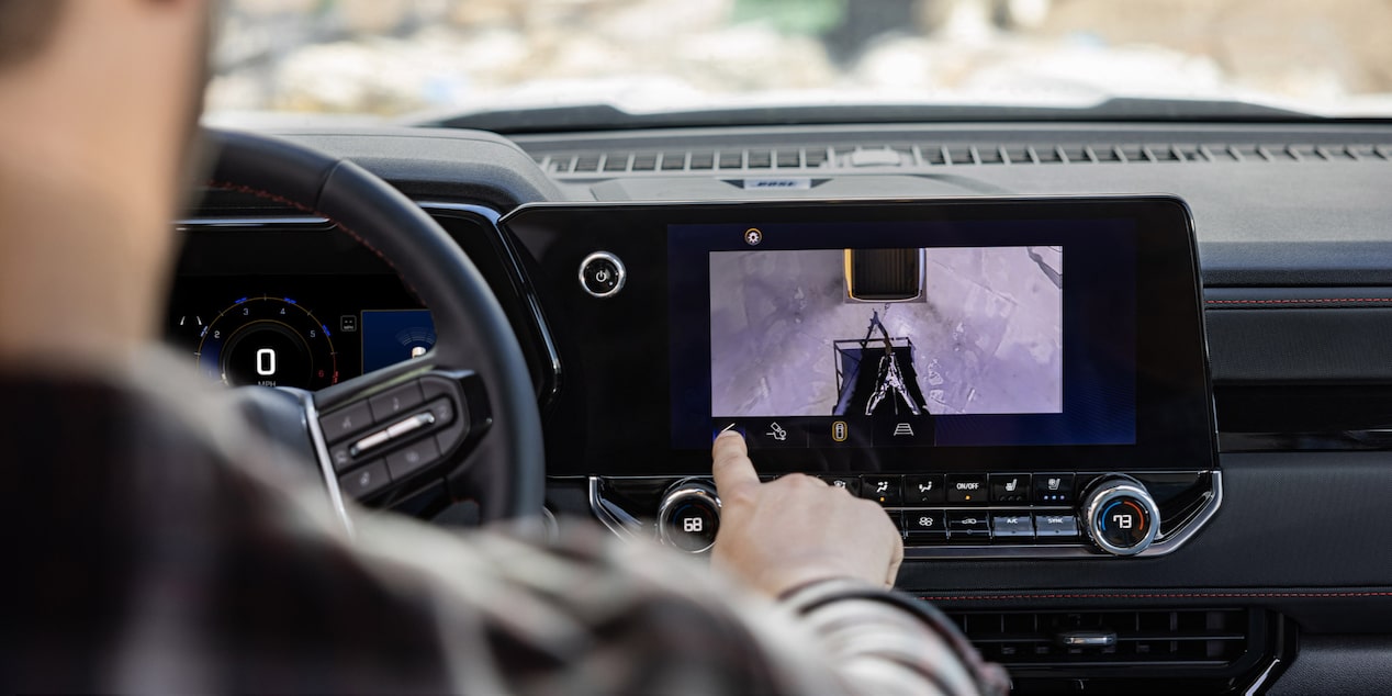 Un conducteur utilisant l’écran du système d’infodivertissement pendant la conduite dans un Chevrolet Colorado 2025.