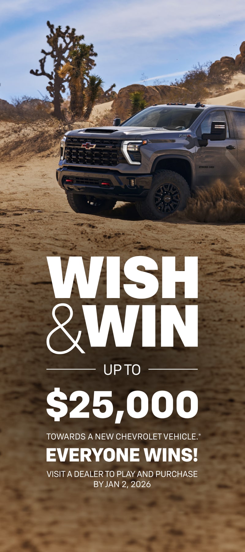 Front-side view of the 2025 Chevrolet Silverado HD pickup truck skidding in a sandy terrain.