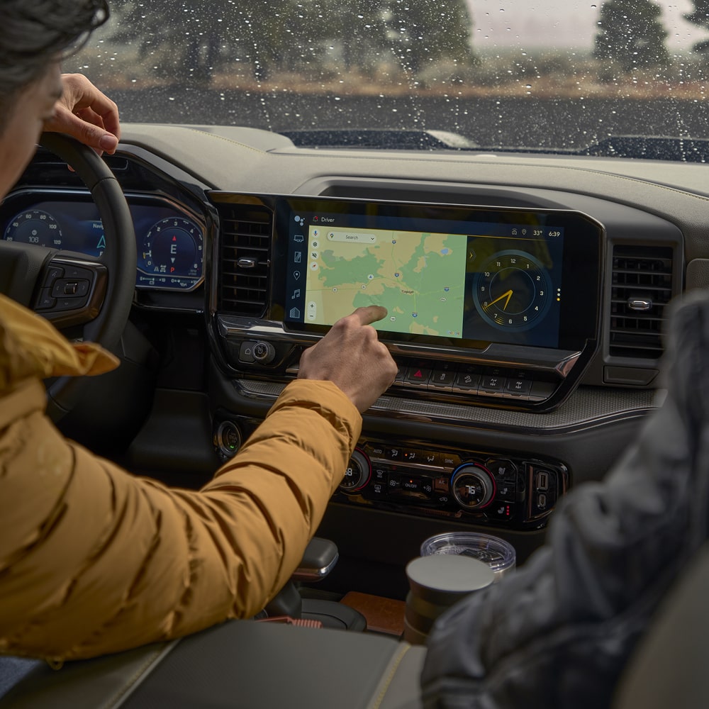 Two people seated at the front row of the 2026 Chevrolet Silverado LD.