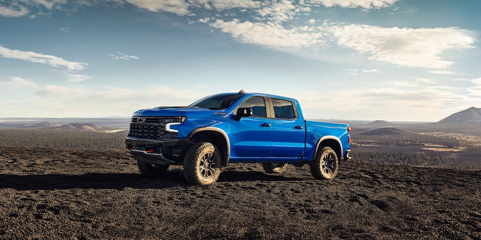 Front-side view of the 2025 Chevrolet Silverado LD parked alone on a sunny day.