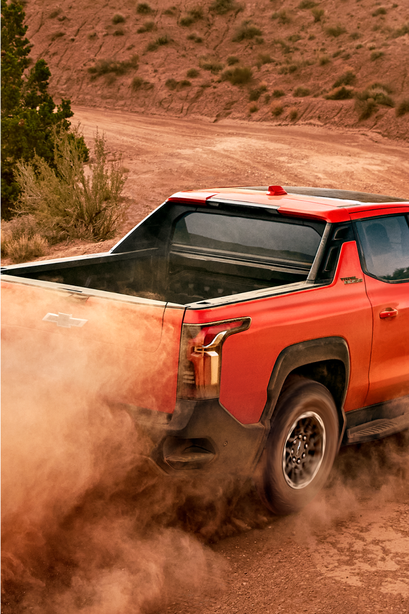 Chevrolet Silverado EV Trail Boss driving on a Dusty Road.