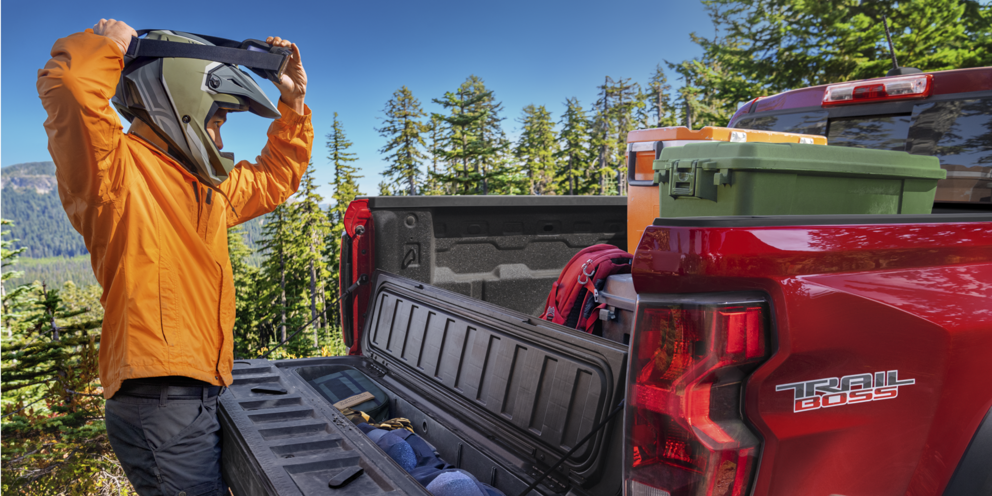 A Biker Taking His Equipment Out of the Bed of the Chevrolet Colorado Trail Boss.