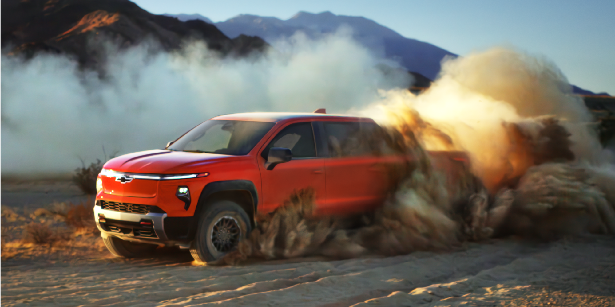 Chevrolet Silverado EV Trail Boss Speeding on an Off-Road Trail and Creating a Dust Cloud.