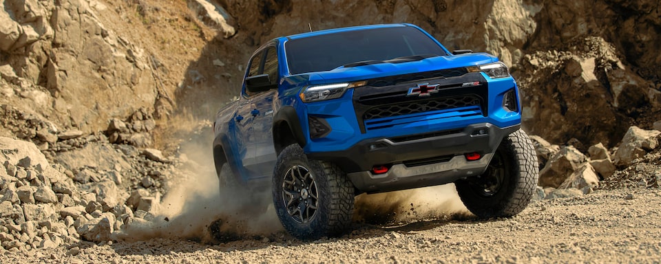 The 2023 Colorado Kicking Up Dirt While Taking an Off-Road Incline with Ease.