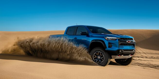 The 2023 Colorado driving through the sand with ease.