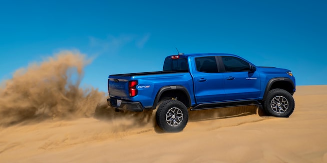 The 2023 Colorado making a steep sand dune look like a residential road.
