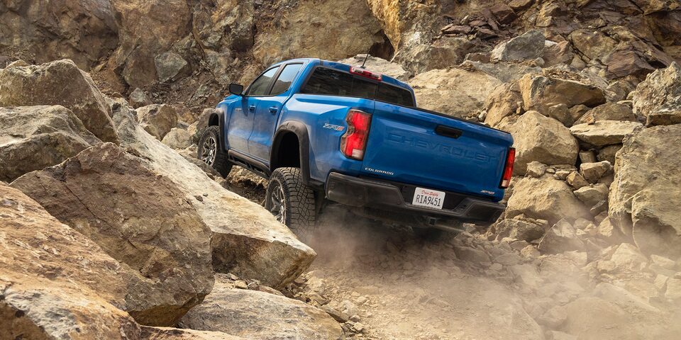 The 2023 Colorado climbing a steep rocky off-road trail.