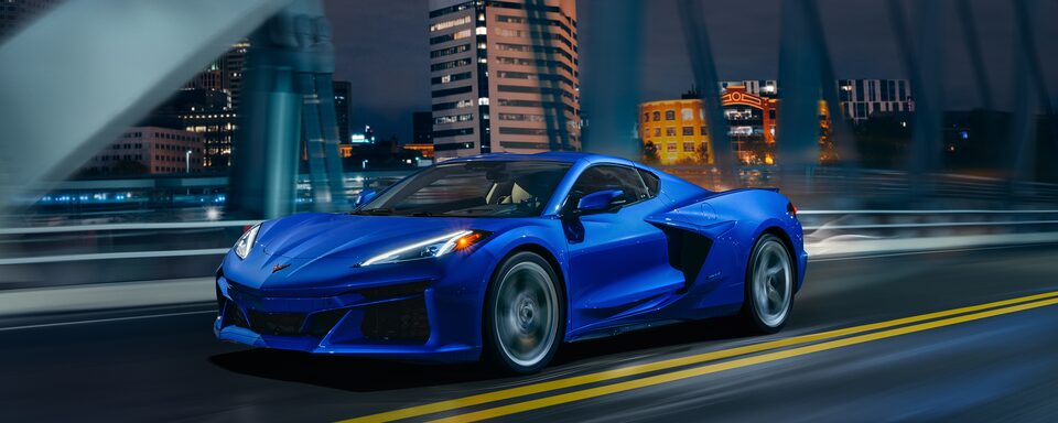 All-New 2024 Corvette E-Ray while driving down a city highway.