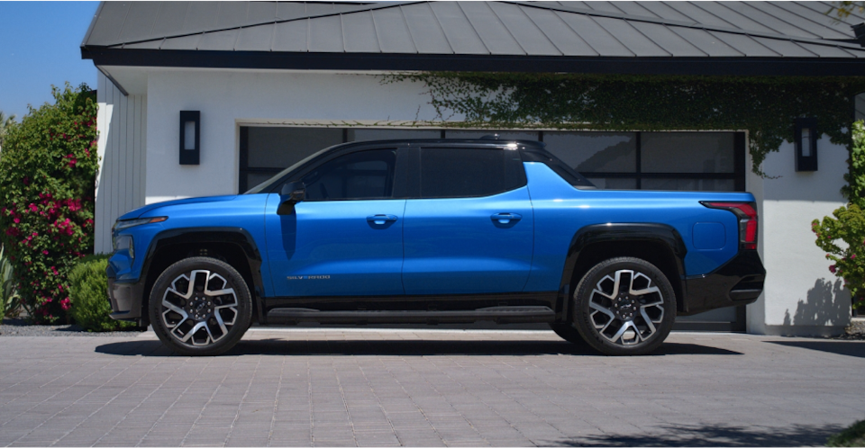 Side view of the 2024 Chevrolet Silverado EV parked in a driveway.