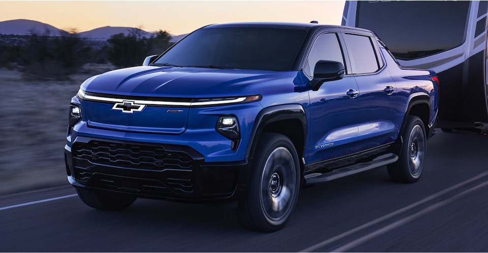 The 2024 Chevrolet Silverado EV towing a large RV camper.