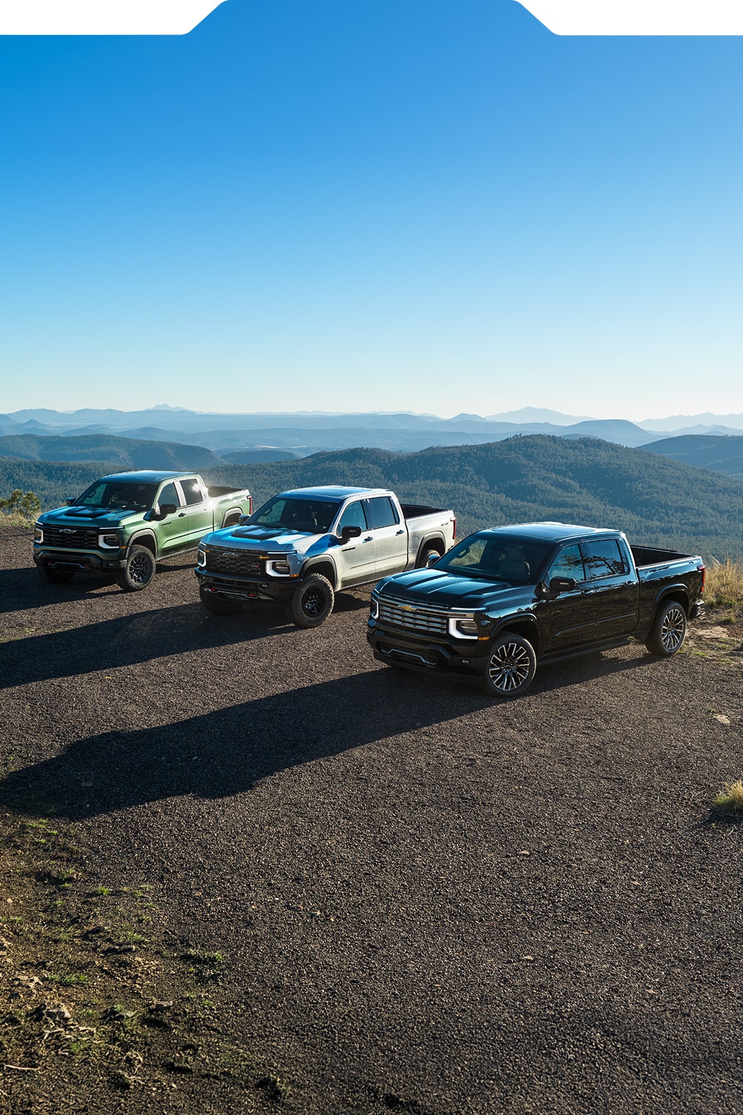 Three Next-Generation 2027 Silverado 1500 Trucks parked beside each other.