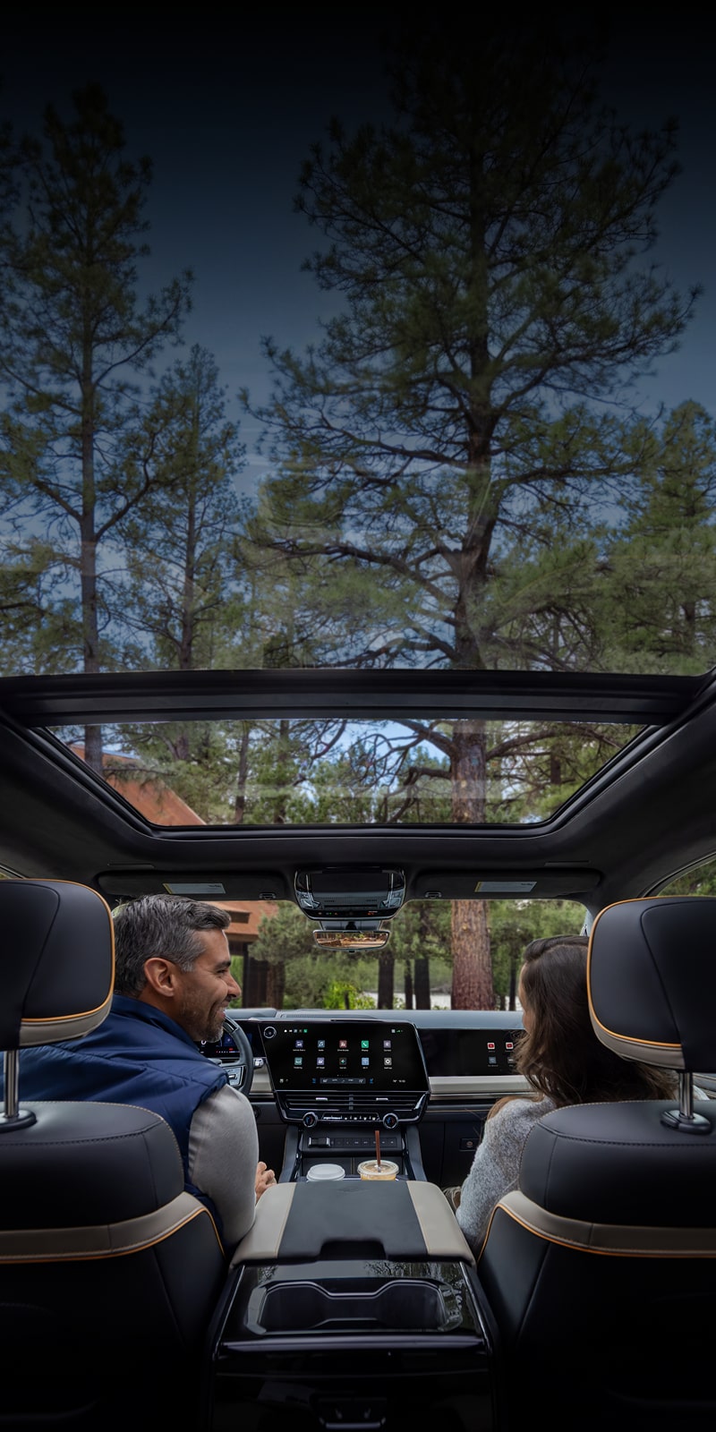 2027 Chevrolet Silverado 1500 interior with panoramic sunroof overlooking a wooded landscape