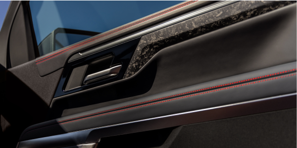 Close-up of forged carbon fibre door trim and red stitching in a 2027 Chevrolet Silverado 1500 ZR2