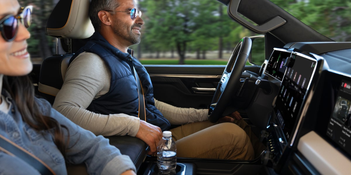 Two people seated at the front seats of the Next-Generation 2027 Silverado 1500 Truck.