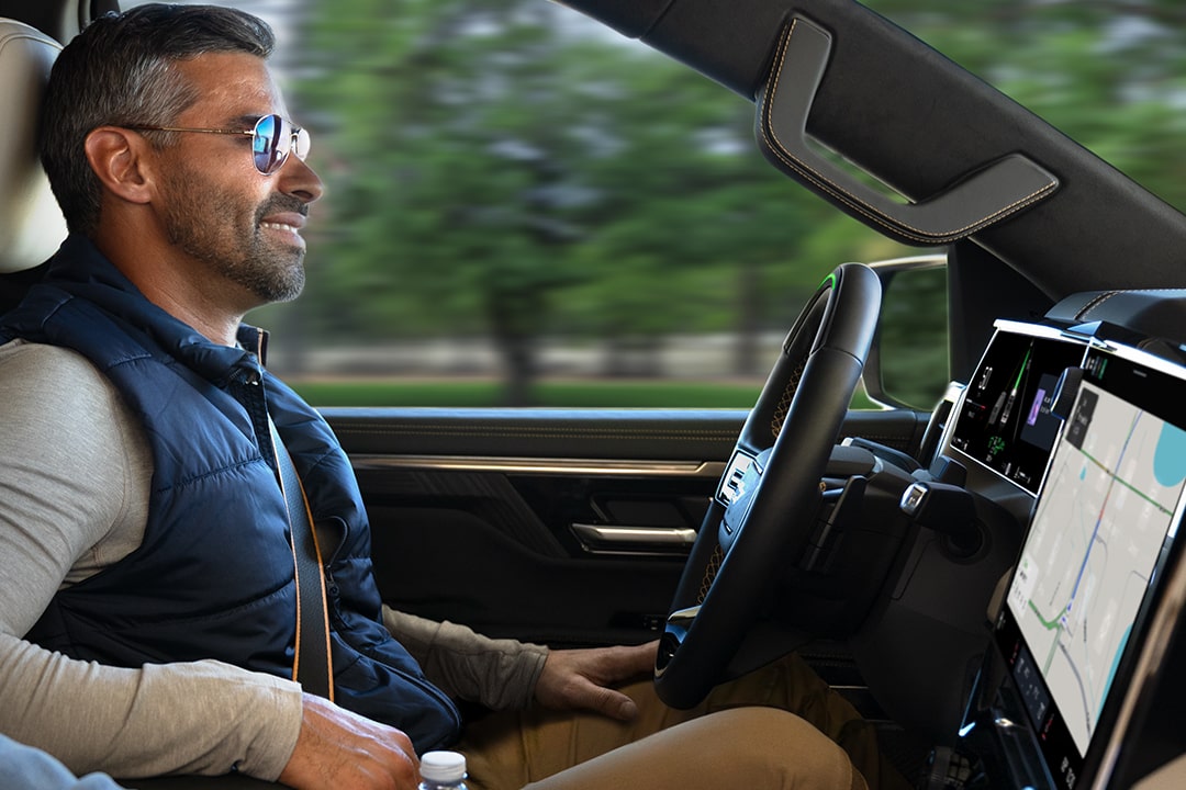 Side view of a person seated at the driver's seat of the Next-Generation 2027 Silverado 1500 Truck.