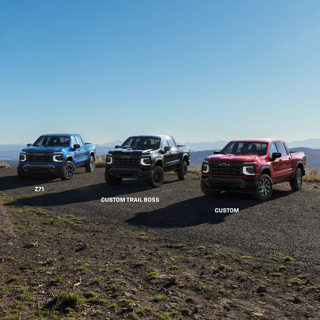 Three Next-Generation 2027 Silverado 1500 Trucks parked by the cliff.
