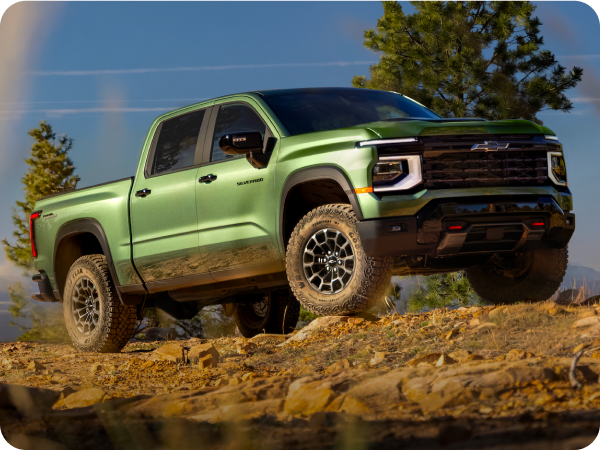 Green 2027 Chevrolet Silverado 1500 Trail Boss on a rugged rocky hill