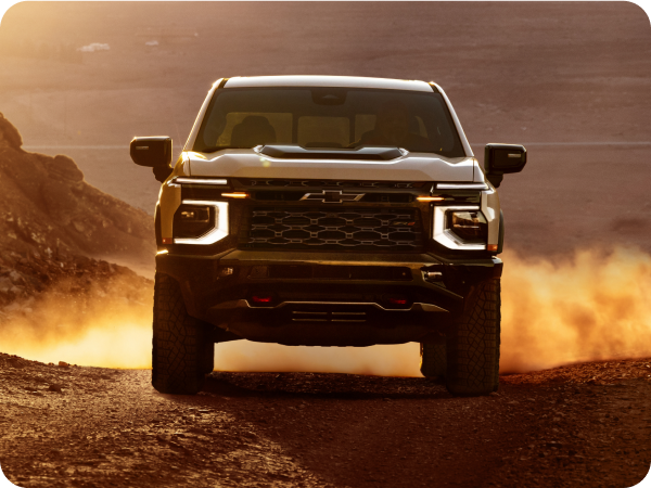 2027 Chevrolet Silverado 1500 ZR2 driving off-road through a dusty desert landscape