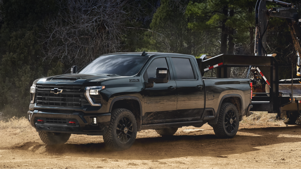 The new 2027 Chevrolet Silverado HD ZR2 pickup truck parked on a sandy desert trail, shown from a front three-quarter angle.