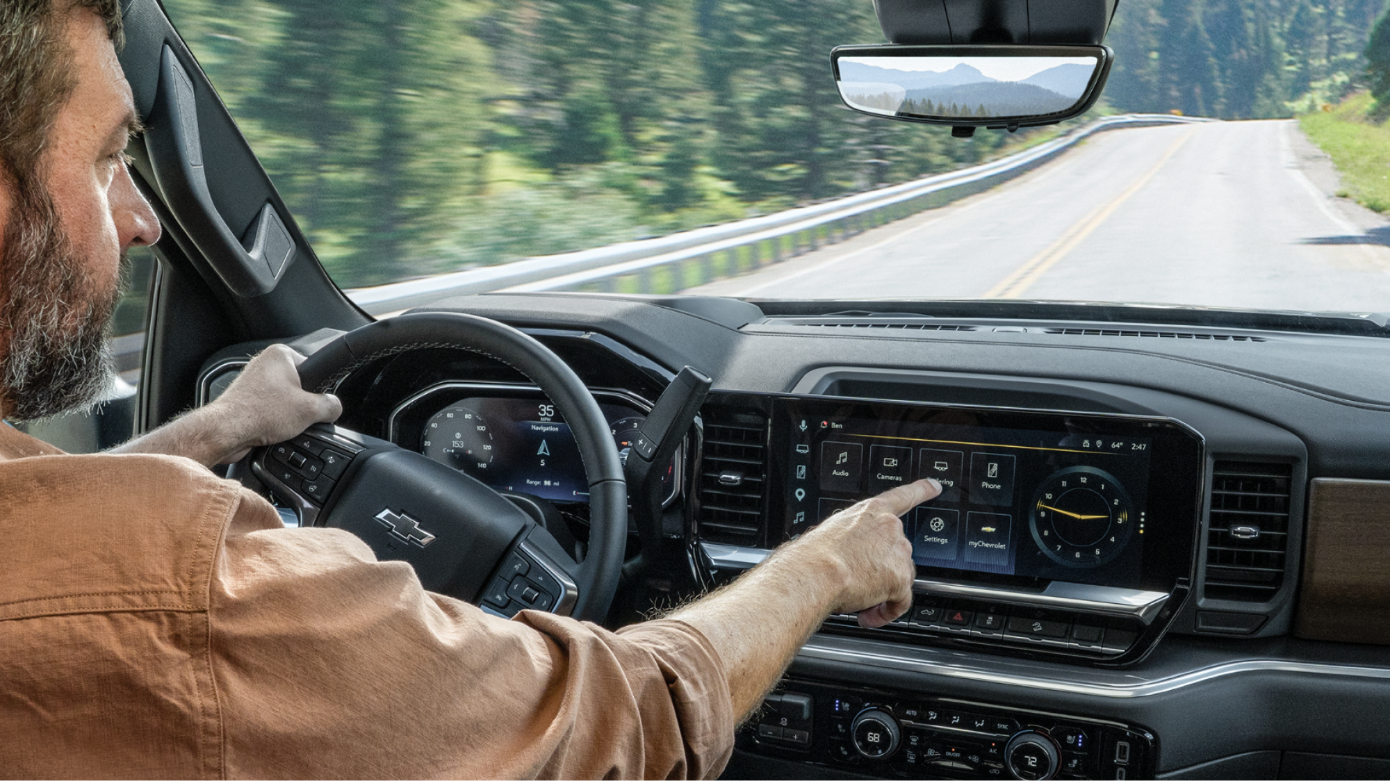Interior view of a 2027 Chevrolet Silverado HD cabin featuring a digital driver information display, steering wheel, large touchscreen infotainment system, and climate control panel.
