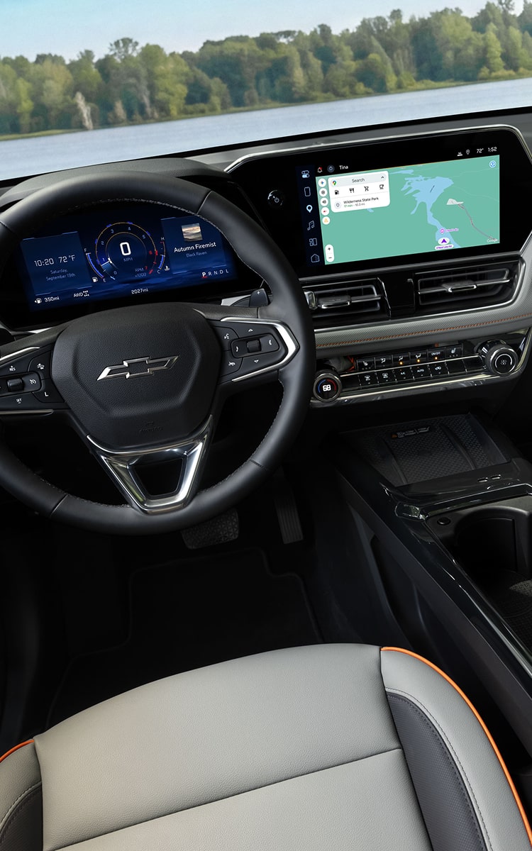 Wide view of the 2027 Chevrolet Trailblazer interior featuring black seats with red accents.