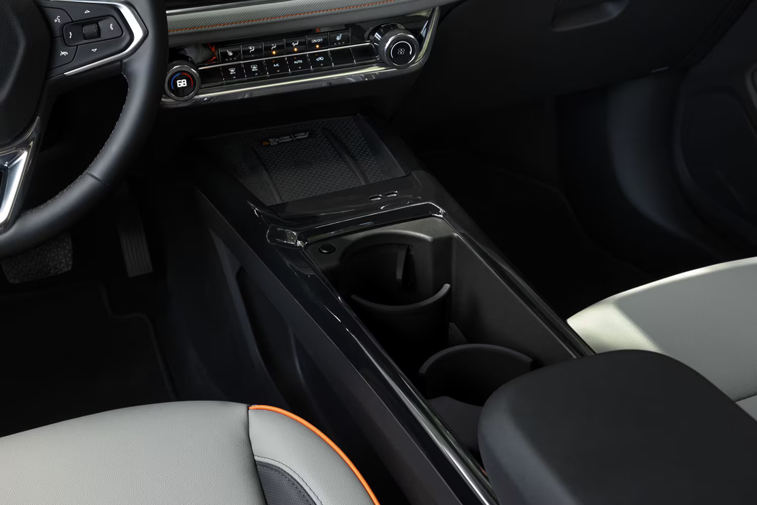 Center console of the 2027 Chevrolet Trailblazer featuring dual cupholders and a storage compartment.